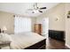 Main bedroom with vaulted ceiling, ceiling fan, and dresser at 7039 Harness Lakes Dr, Indianapolis, IN 46217