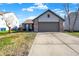 Brick ranch home with attached garage and landscaped yard at 7039 Harness Lakes Dr, Indianapolis, IN 46217