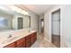 Bathroom with double vanity, large mirror, and a separate tub at 7134 Langham Ct, Indianapolis, IN 46259