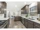 Modern kitchen with dark cabinetry, granite countertops and stainless steel appliances at 7421 Frederick E Dr, Indianapolis, IN 46260