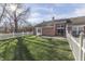 Brick home with fenced backyard, patio, and swing at 7455 Oak Knoll Dr, Indianapolis, IN 46217