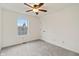 Simple bedroom featuring a ceiling fan and large window at 7548 Crickwood Ln, Indianapolis, IN 46268