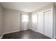 Bedroom with dark floors, neutral walls, and gray curtains at 1003 Avalon Ln, Anderson, IN 46017