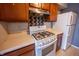 White Samsung gas range and wood cabinets in this galley kitchen at 1068 Greenwood Trail W W Dr, Greenwood, IN 46142