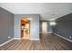 Living room with wood-look floors, kitchen access, and hallway view at 1068 Greenwood Trail W W Dr, Greenwood, IN 46142