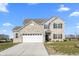 Two story brick home with a large white garage door and landscaped lawn at 1098 Bent Branch Ln, Greenwood, IN 46143