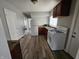 Efficient kitchen with white appliances and wood cabinets at 1118 N Dearborn St, Indianapolis, IN 46201