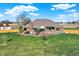 Backyard view of house, patio, and landscaped grounds at 11262 N Everett Rd, Monrovia, IN 46157