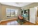 Bright bedroom with wood floors, built-in desk, and large window at 11262 N Everett Rd, Monrovia, IN 46157