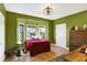 Green bedroom with wood floors, a bed, and ample natural light at 11262 N Everett Rd, Monrovia, IN 46157