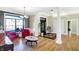 Bright entryway with hardwood floors, red accent chairs, and a view to the living room at 11262 N Everett Rd, Monrovia, IN 46157