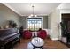 Living room with hardwood floors, piano, and two red armchairs at 11262 N Everett Rd, Monrovia, IN 46157