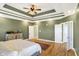 Large main bedroom with hardwood floors, green walls, and access to bathroom at 11262 N Everett Rd, Monrovia, IN 46157