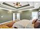 Main bedroom with hardwood floors, green walls, and access to bathroom at 11262 N Everett Rd, Monrovia, IN 46157