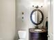 Stylish powder room with a dark vanity and an ornate mirror at 11262 N Everett Rd, Monrovia, IN 46157