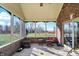 Relaxing screened porch with brick walls and view of the backyard at 11262 N Everett Rd, Monrovia, IN 46157