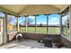 Relaxing screened porch with brick flooring and a fire pit, overlooking the backyard at 11262 N Everett Rd, Monrovia, IN 46157