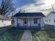 White house with front porch and small yard at 1809 E Hines St, Muncie, IN 47303