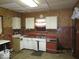 Kitchen with white cabinets, red countertops, and brick backsplash at 205 S Arsenal Ave, Indianapolis, IN 46201