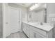 Double vanity bathroom with quartz countertop and gray tile floor at 308 Brunswick Way, Zionsville, IN 46077