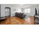 Living room with hardwood floors, gray couch, and large windows at 315 W 37Th St, Anderson, IN 46013