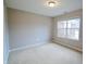 Bright bedroom with neutral walls and carpet, featuring a large window at 4126 S Black Oak Ln, New Palestine, IN 46163