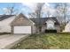 Brick ranch home with attached garage and landscaped lawn at 5457 Great Woods Dr, Indianapolis, IN 46224