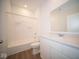 Clean bathroom with white vanity, tub shower, and mirror at 5607 Tart Blvd, Indianapolis, IN 46239