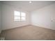 Well-lit bedroom with neutral carpet and window at 5607 Tart Blvd, Indianapolis, IN 46239