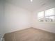 Spacious bedroom with neutral carpeting and a large window at 5607 Tart Blvd, Indianapolis, IN 46239
