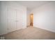 Simple bedroom with neutral carpeting and double doors to closet at 5607 Tart Blvd, Indianapolis, IN 46239