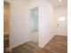 Bright entry hall with wood-look flooring, leading to a bedroom and bathroom at 5607 Tart Blvd, Indianapolis, IN 46239