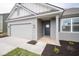 Gray house with white accents, a two-car garage, and a landscaped lawn at 5607 Tart Blvd, Indianapolis, IN 46239