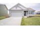 Gray house with white accents, a two-car garage, and a landscaped lawn at 5607 Tart Blvd, Indianapolis, IN 46239