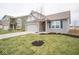 Gray house with white accents, a two-car garage, and a landscaped lawn at 5607 Tart Blvd, Indianapolis, IN 46239