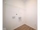 Bright laundry room with wire shelving and vinyl flooring at 5607 Tart Blvd, Indianapolis, IN 46239