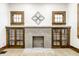 Living room features a fireplace, built-in shelving, hardwood floors, and large windows at 621 N Denny St, Indianapolis, IN 46201