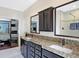 Bathroom with dual vanity, granite countertops, and a view of the bedroom at 691 S 1100 E, Zionsville, IN 46077