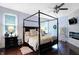 Main bedroom with a large black canopy bed, fireplace, and TV at 691 S 1100 E, Zionsville, IN 46077