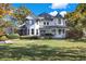 Two-story home with a turret and wrap-around porch, beautiful autumn foliage at 691 S 1100 E, Zionsville, IN 46077