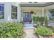 Inviting front entrance with a blue door, flower pots, and a charming walkway at 691 S 1100 E, Zionsville, IN 46077