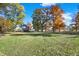 Large grassy area with mature trees and a home in the background at 691 S 1100 E, Zionsville, IN 46077