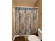 Clean bathroom with a shower/tub combo and patterned shower curtain at 8298 S Firefly Dr, Pendleton, IN 46064