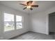 Spacious bedroom with grey carpet, ceiling fan and window with a view at 924 Delegate Dr, Shelbyville, IN 46176