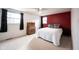 Bedroom with double bed and red accent wall at 9415 Thornwood Dr, Indianapolis, IN 46250