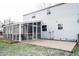 Rear view of house with screened porch and patio at 9415 Thornwood Dr, Indianapolis, IN 46250