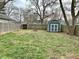 Fenced backyard with a storage shed and fire pit at 2104 N Ball Ave, Muncie, IN 47304