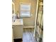 Bathroom with white vanity, marble countertop, and gray-wood tile floor at 2104 N Ball Ave, Muncie, IN 47304