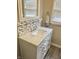 Bathroom with white vanity, marble countertop, and mosaic backsplash at 2104 N Ball Ave, Muncie, IN 47304