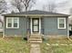 Gray siding house with a white door, steps and landscaping at 2104 N Ball Ave, Muncie, IN 47304